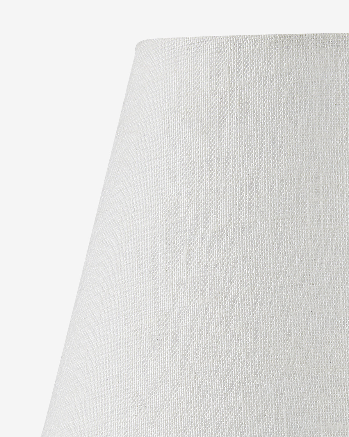 Close-up of the upper part of the Piccolo Table Lamp’s white, textured conical shade, shown against a white background. The elegant lamp features a subtle woven pattern and is complemented by a striking red marble base, by Vendixs