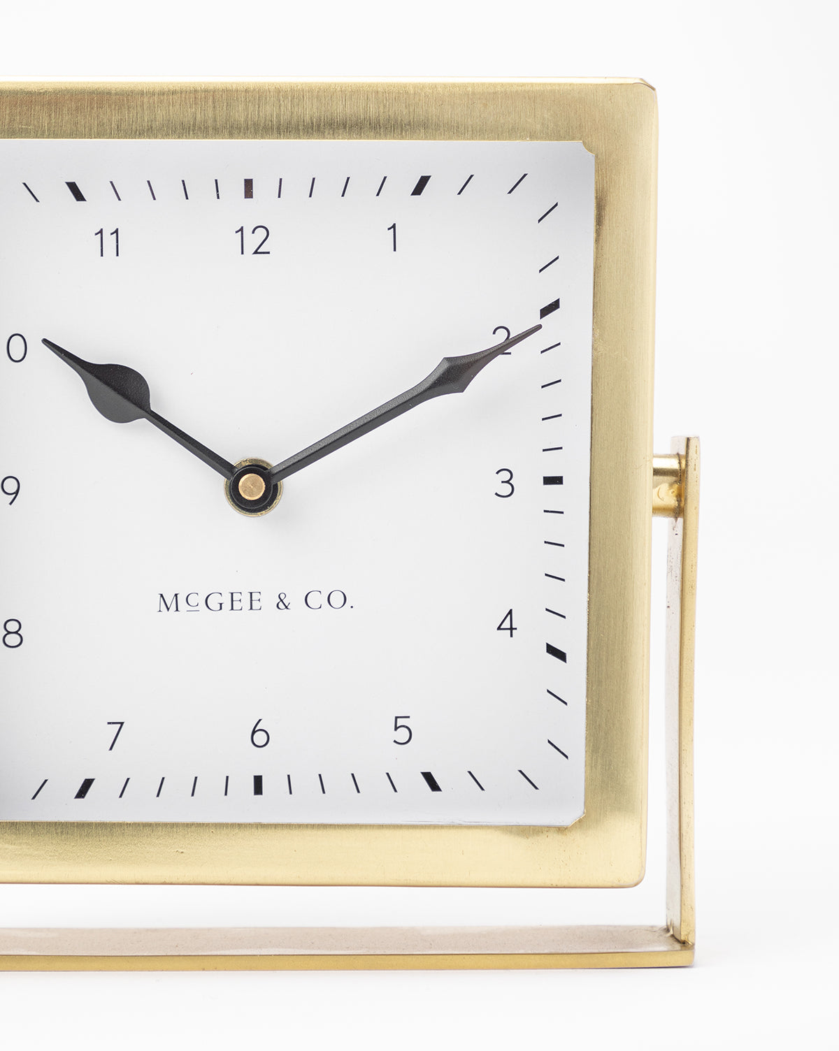 The Posey Table Clock features a square gold frame, white face, black tick marks, and black hands set to 10:10, with Vendixs at the center—an ideal nightstand clock or stylish desk accessory.
