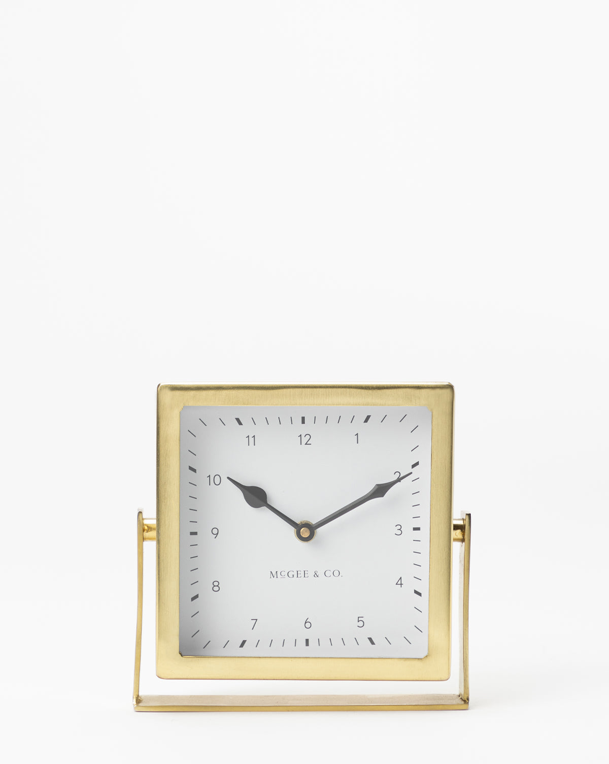 The Posey Table Clock is a square gold nightstand clock with black hour and minute hands, a white face with black numerals, and Vendixs printed near the bottom—an elegant, timeless addition to any table or desk.