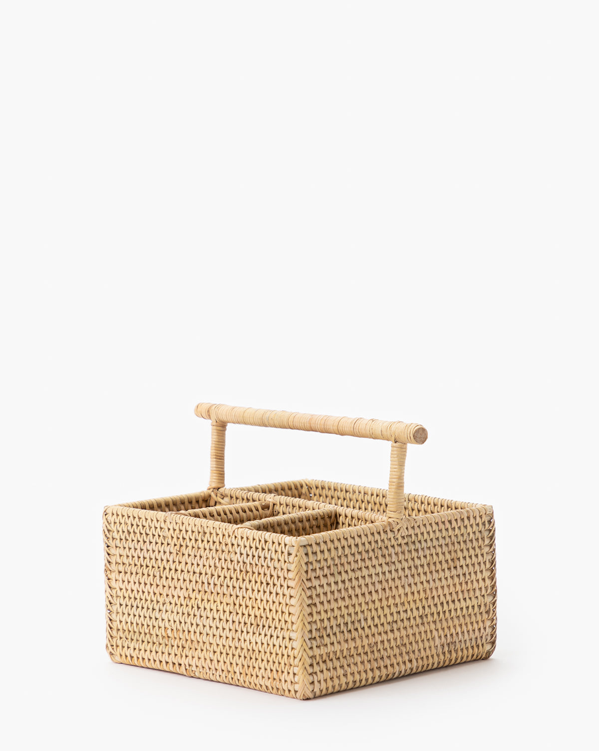 The Rattan Utensil Caddy is a square, woven organizer with a sturdy handle and divided compartments, ideal as a picnic utensil holder, by Vendixs Shown against a plain white background.