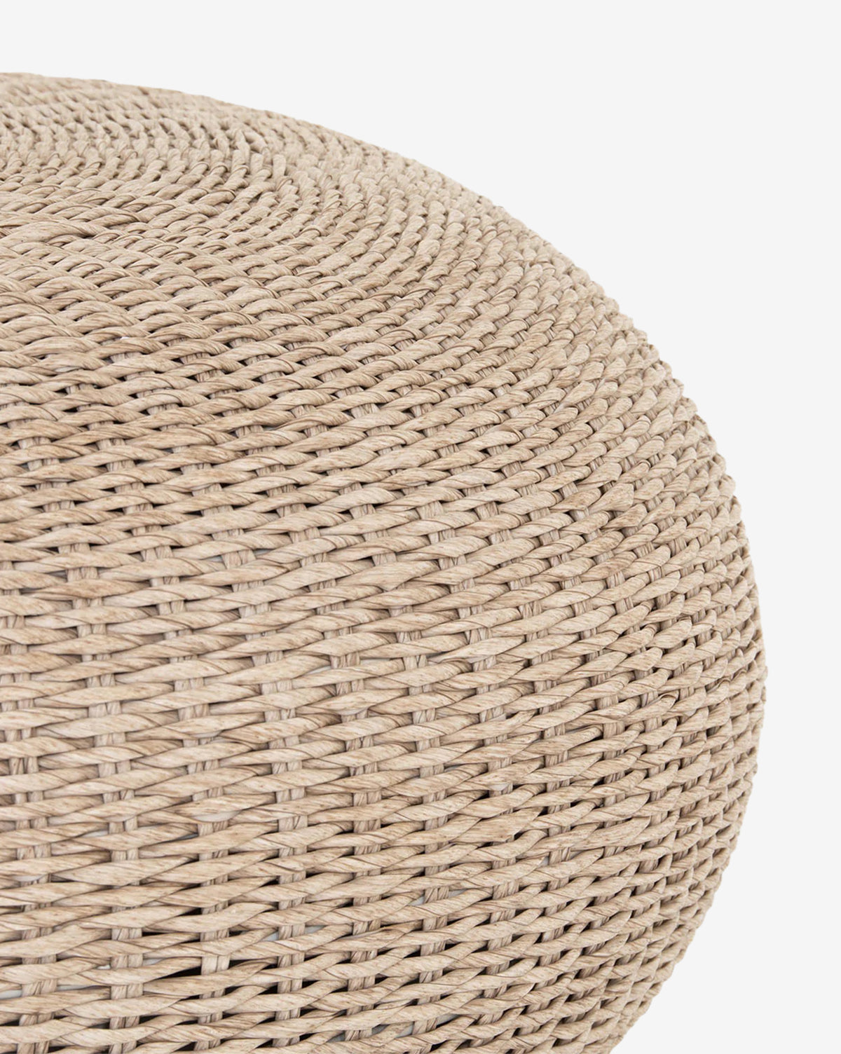 Close-up of the Rimma Outdoor Coffee Table, a round beige all-weather wicker piece with a smooth, curved surface and tightly braided texture, shown on a white background, by Vendixs