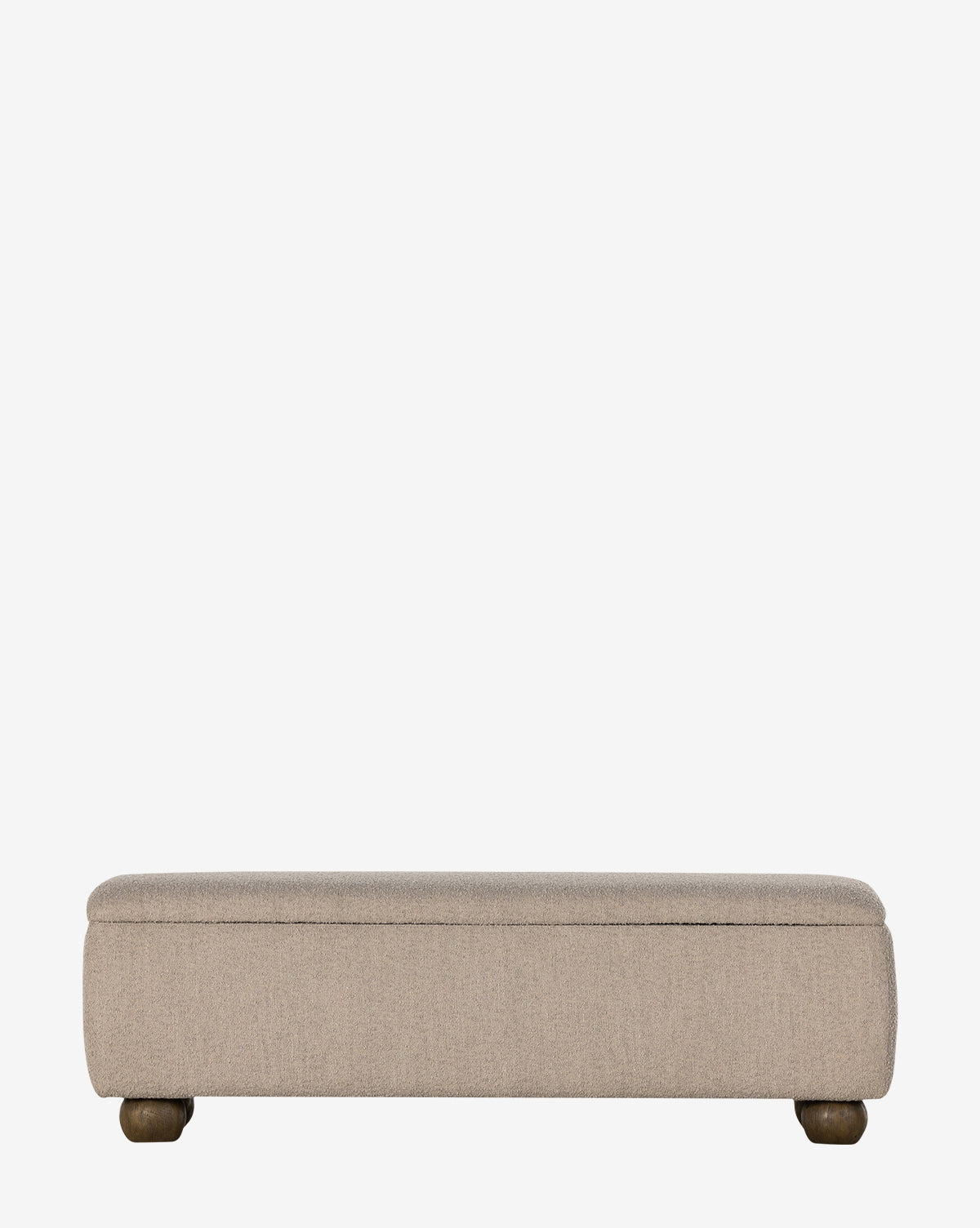 The Rowley Trunk by Four Hands is a rectangular beige upholstered storage trunk with rounded corners and short wooden legs in a modern design, shown against a plain white background. Vendixs