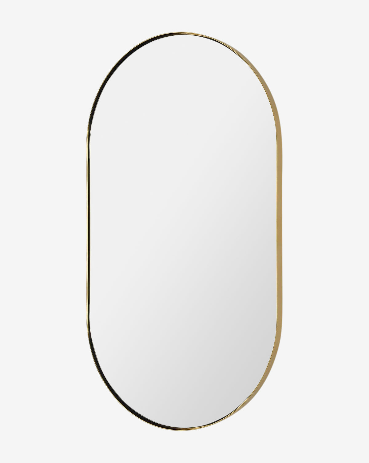 The Rye Wall Mirror features an oval design with a slim gold metal frame, bringing modern elegance to any white wall, by Vendixs