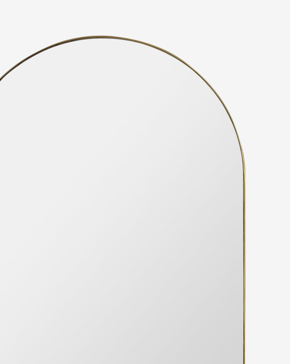 The Rye Wall Mirror, featuring a large arched shape and a slim gold stainless steel frame, is displayed against a plain white background, by Vendixs