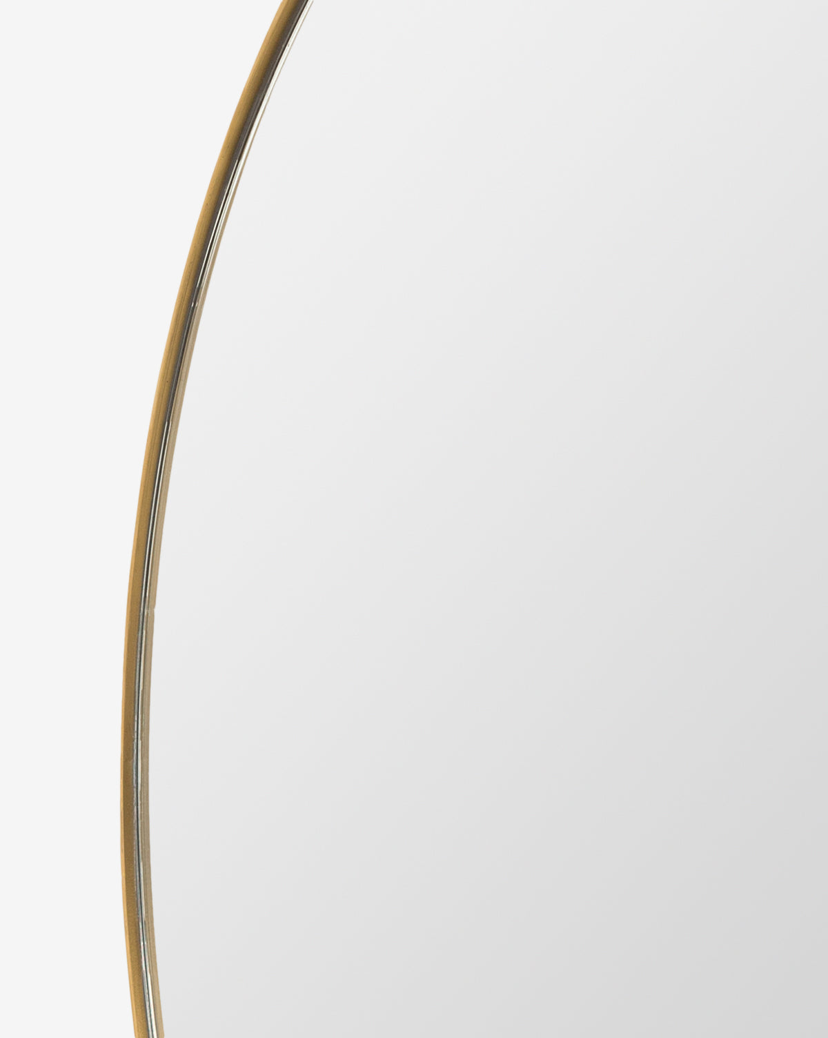 A close-up of the Solange Mirror shows its modern, minimalist style with a thin stainless steel frame against a white background. Only part of the round mirror is visible, highlighting its contemporary design, by Vendixs
