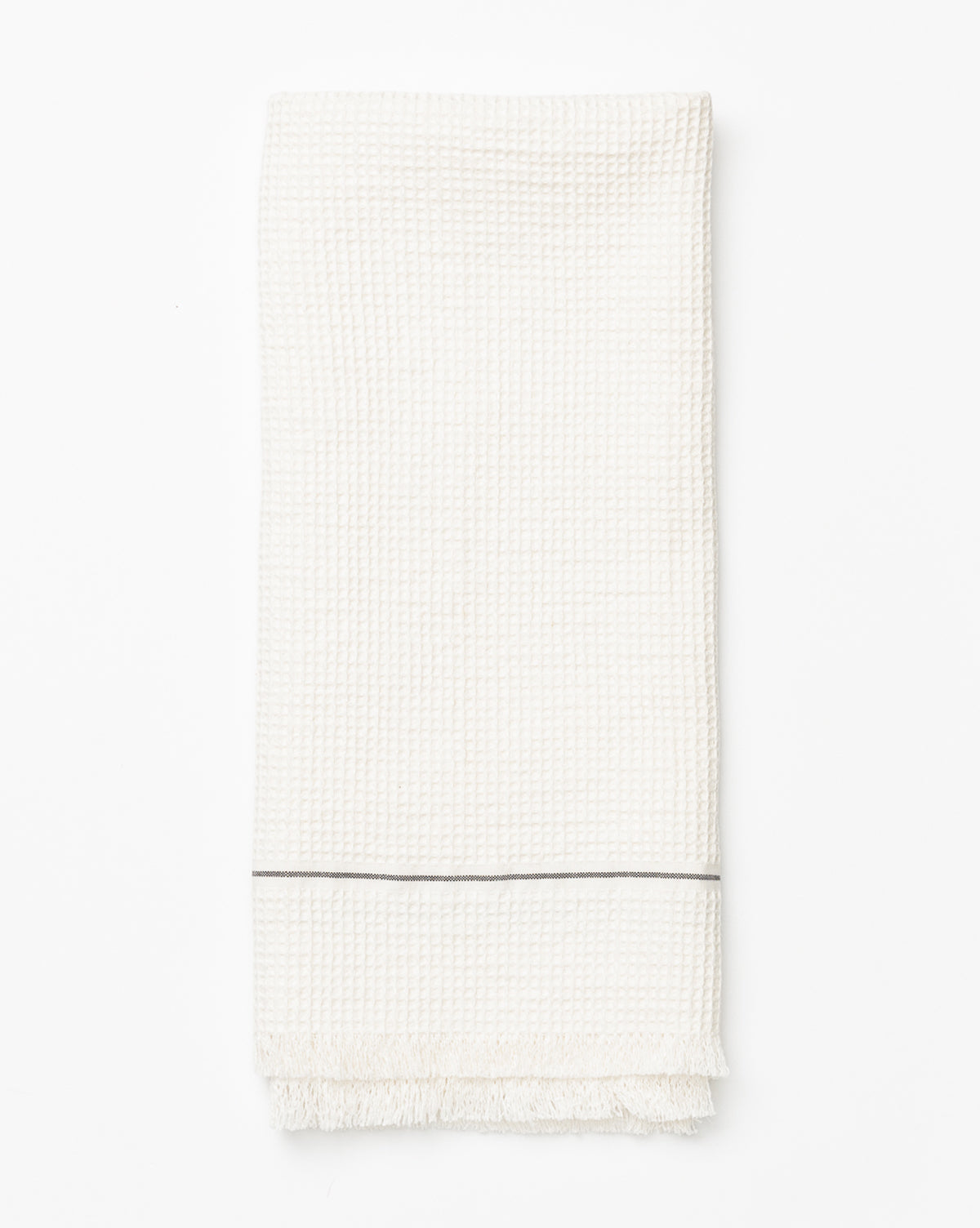 The Waffle Hand Towel features a subtle textured pattern, a thin gray stripe near one end, and short fringes along the edge. Neatly folded and displayed on a white background, it’s perfect for enhancing your kitchen decor, by Vendixs