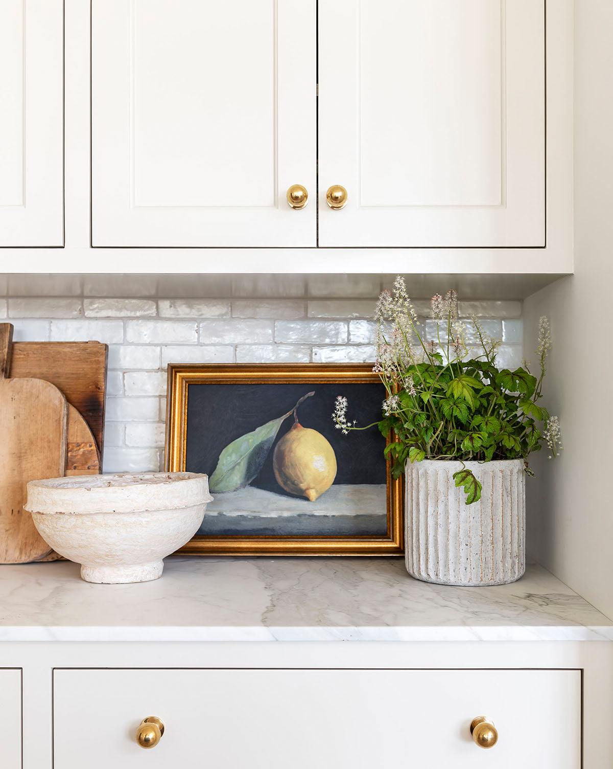 Whitewashed Ridge Pot in small size on kitchen counter with flowering greens, from Vendixs

